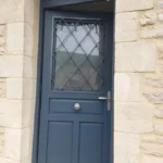 Porte d'entrée, modèle Anémone, grille Savoie, bouton inox, ouvrant dans l'ouvrant, imposte, gamme HYBRIDE
