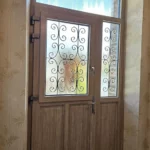 Porte d'entrée, modèle Chicorée 2, grille Lorraine, ouvrant dans l'ouvrant, tierce avec grille, imposte, teck de Java, gamme TEXTURAL®