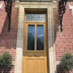 Porte d'entrée, modèle Domino, grille Castille, chêne irlandais, gamme TEXTURAL®
