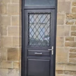 Porte d'entrée, modèle Anémone, tirant horizontal, grille Alpes, imposte, gamme HYBRIDE